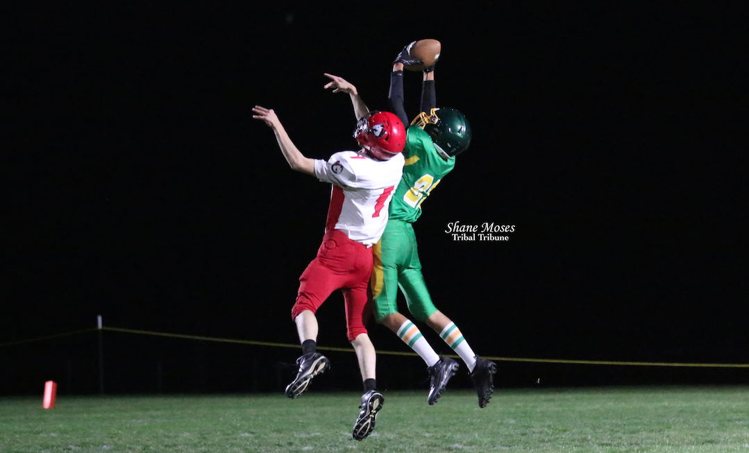 Inchelium’s Duke Finley (#21 green) goes up for the catch against Northport on Friday (Oct. 8) evening in NE 1B League action.