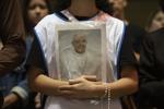 A devotee holds an image of Pope Francis