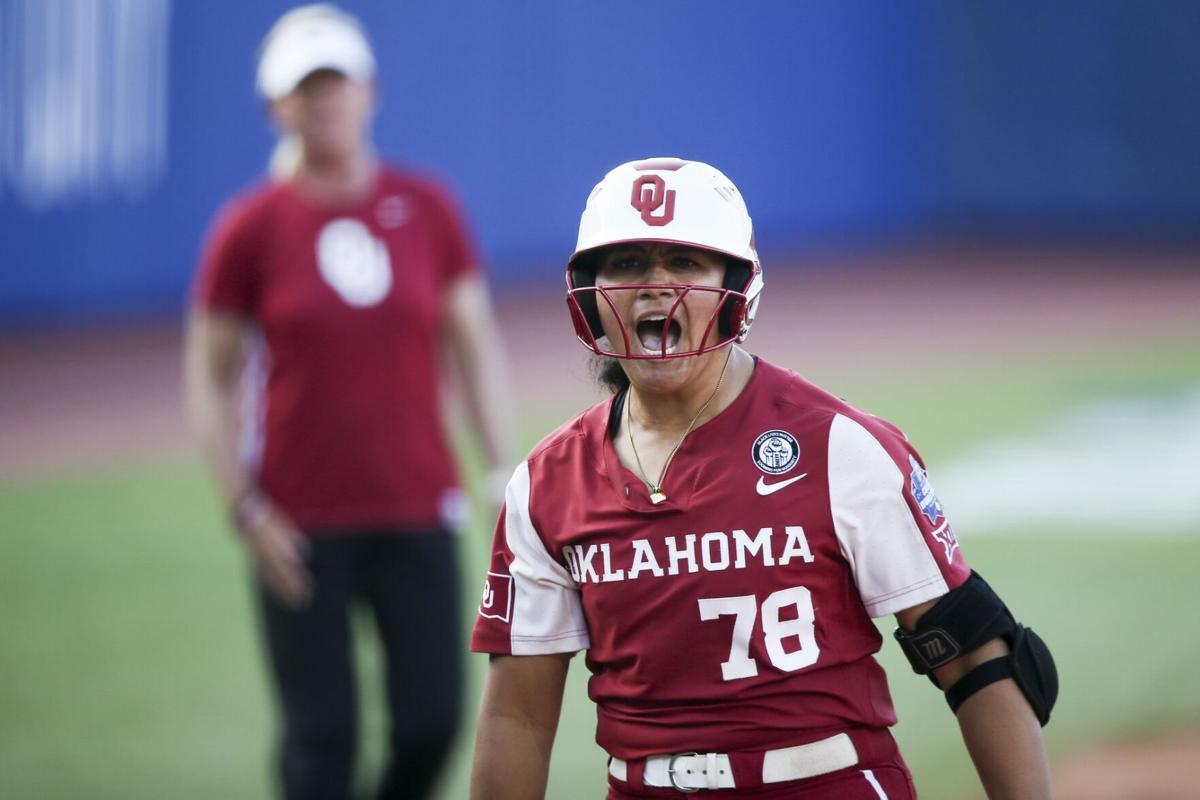 D-backs third base coach watching his daughter at the WCWS