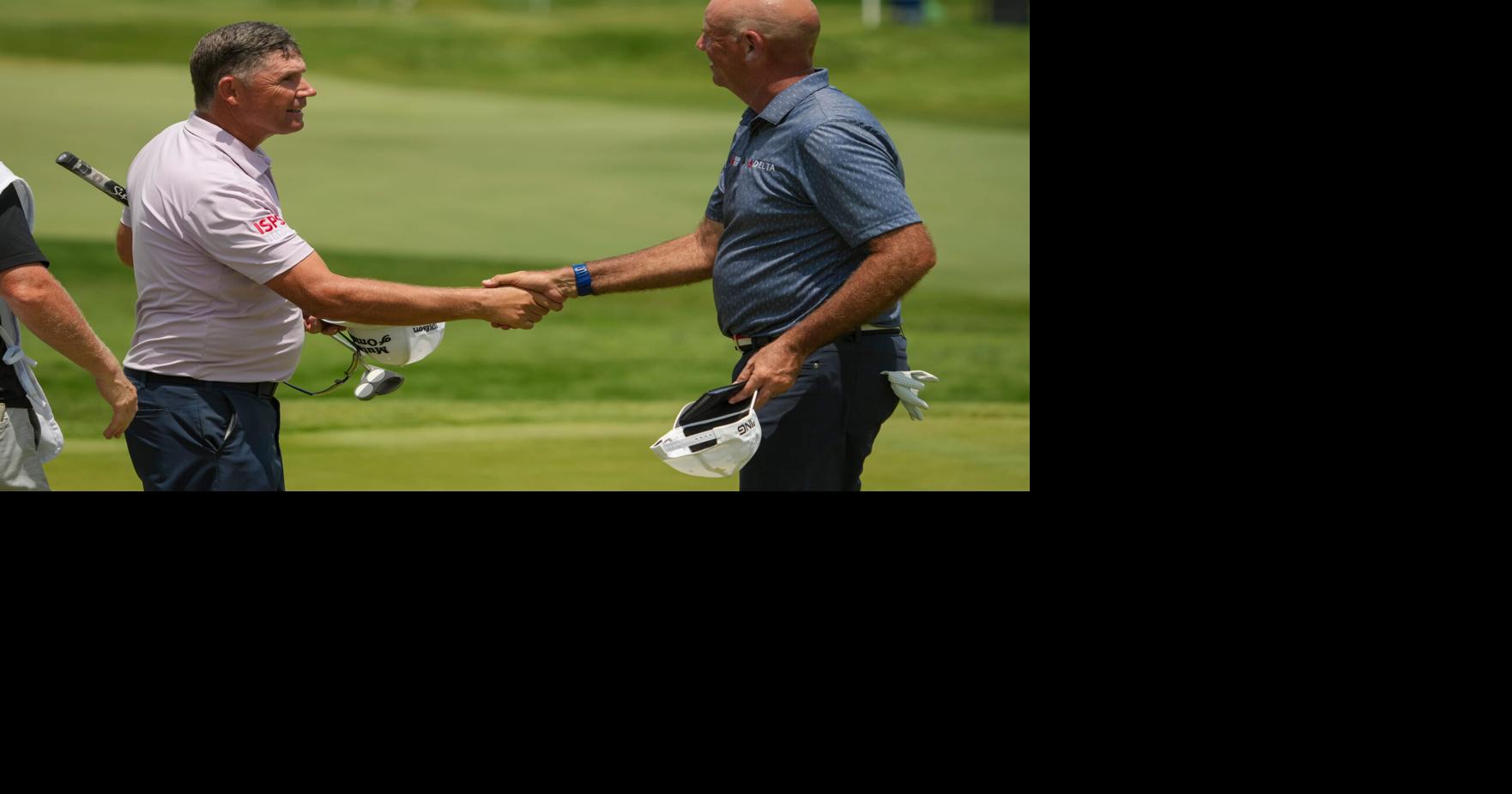 Padraig Harrington and Stewart Cink shake hands following the third round of the U.S. Senior Open at Scioto Country Club in