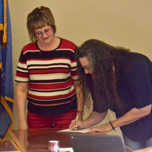 Jessica Hardcastle signs the WPS paperwork