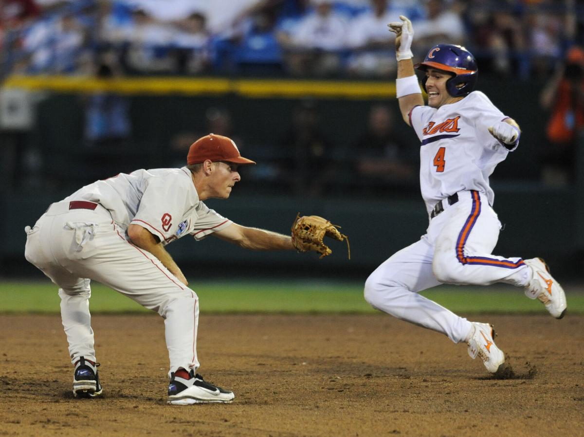 South Carolina's Whit Merrifield beats the throw to Clemson third baseman  John Hinson (4), after Merrifield hit a triple in the fifth inning of an  NCAA College World Series baseball elimination game