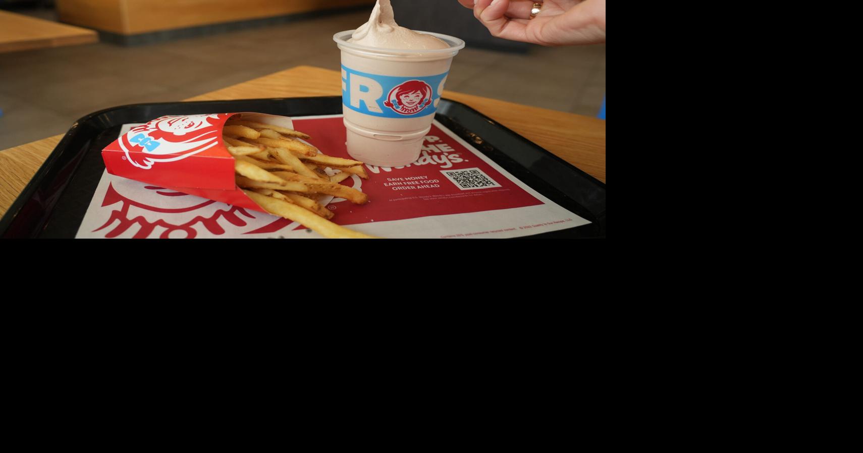 A diner dips her french fries into a Frosty at a new Wendy's restaurant in Powell, Ohio, a suburb of Columbus. The restaurant chain is headquartered in another Columbus suburb, Dublin.