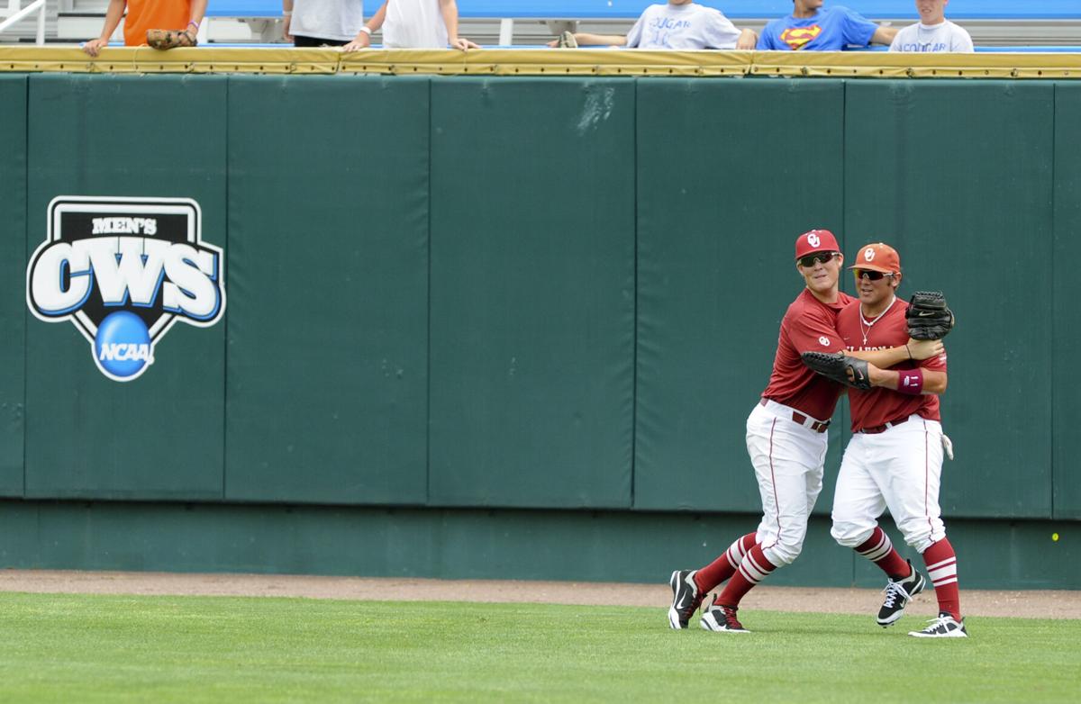 South Carolina's Whit Merrifield beats the throw to Clemson third baseman  John Hinson (4), after Merrifield hit a triple in the fifth inning of an  NCAA College World Series baseball elimination game