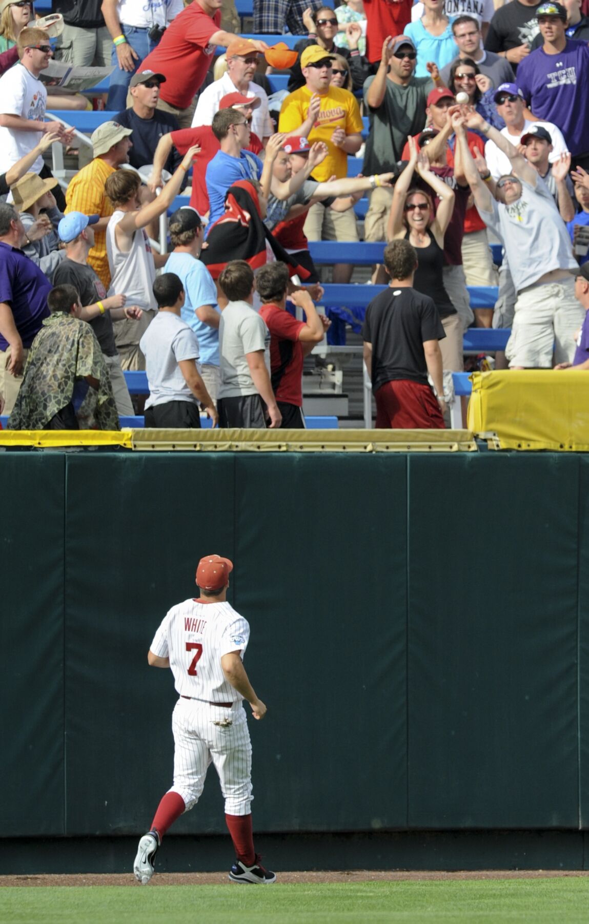 South Carolina's Whit Merrifield beats the throw to Clemson third baseman  John Hinson (4), after Merrifield hit a triple in the fifth inning of an  NCAA College World Series baseball elimination game