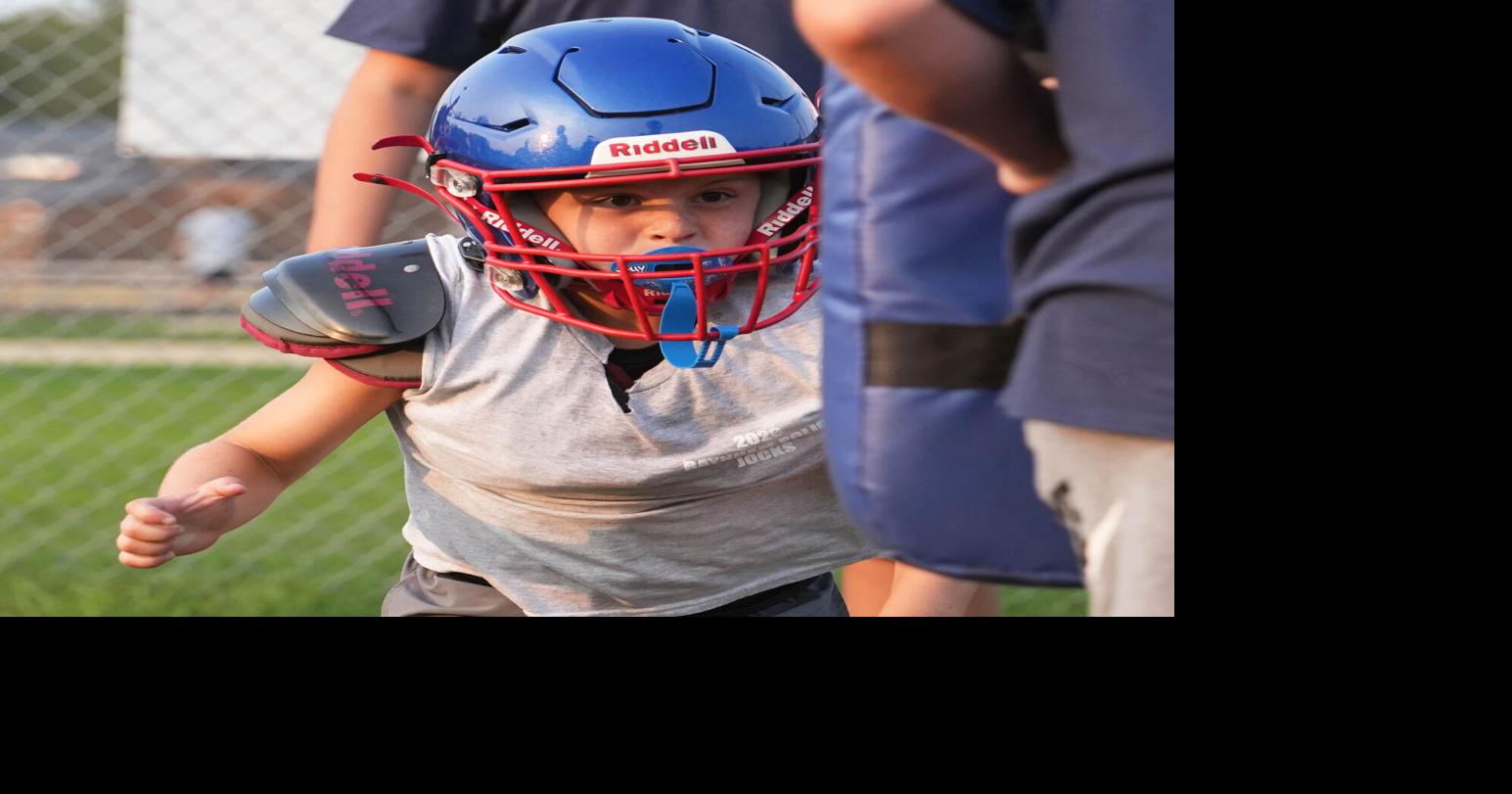 Bryce Avitabile, 7, hits a tackling pad at the Raynham Police Department Juvenile Organization of Cops and Kids (J.O.C.K.S.)