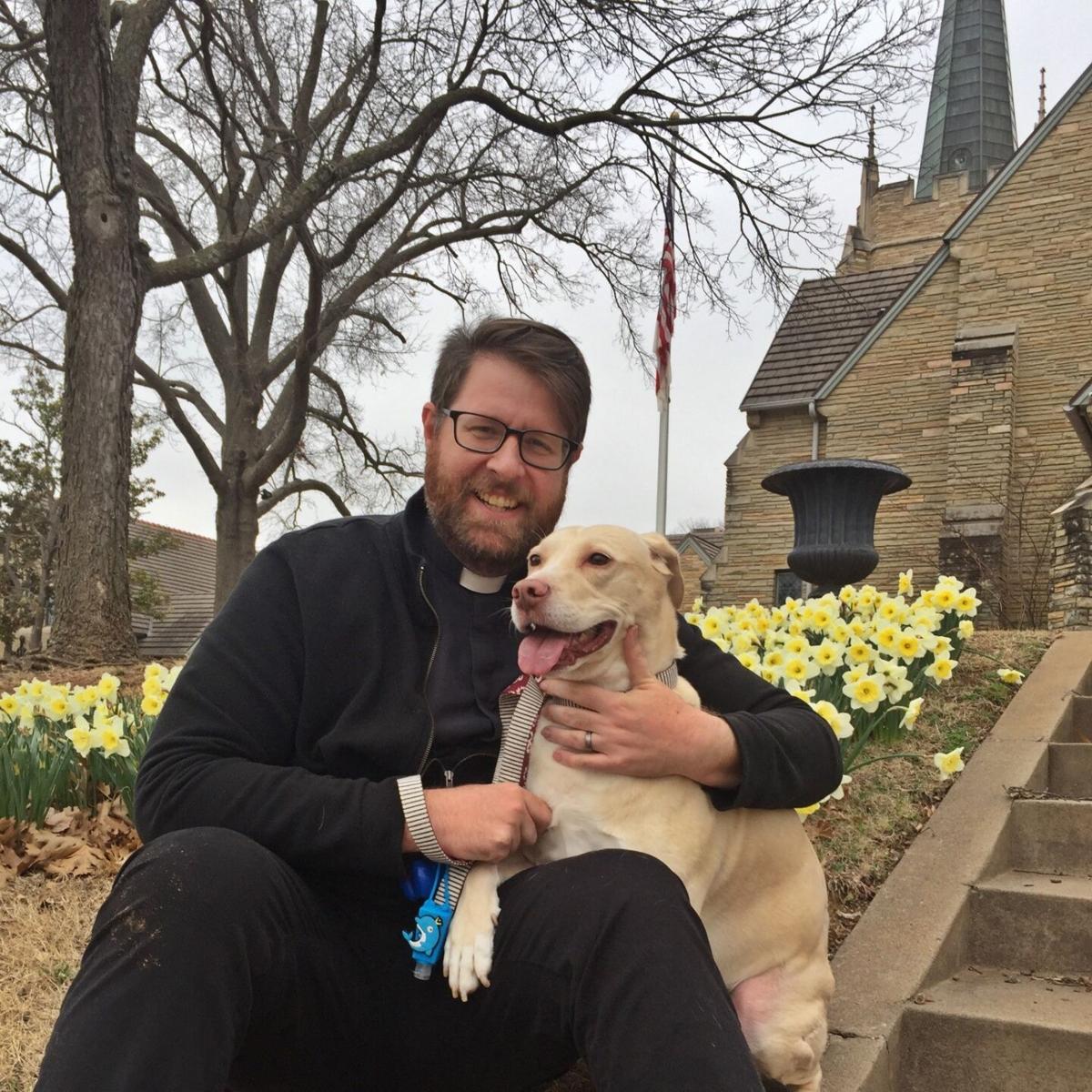 Father David Bumsted and his dog, named Cat.