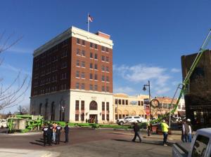 Construction vehicle falls over, damages building in Bartlesville