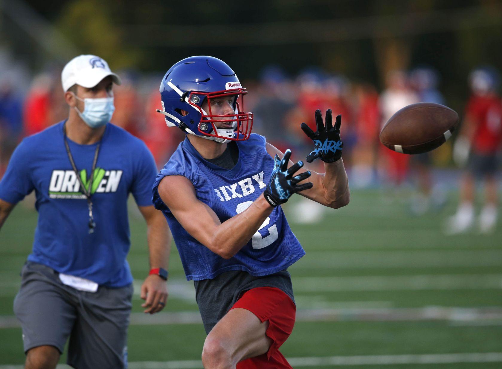 High school football practice opens with teams balancing preparations