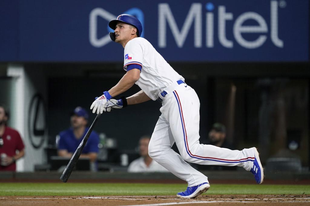 Kole Calhoun of the Texas Rangers runs the bases after hitting a