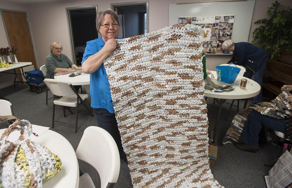 Volunteers use plastic grocery bags to make sleeping mats for homeless ...
