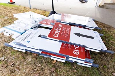 COVID-19 testing signs piled