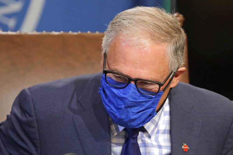 Washington Gov. Jay Inslee, shown during a news conference in June, announced a plan to restore visits at long-term care facilities, where restrictions have been in place through the pandemic. 