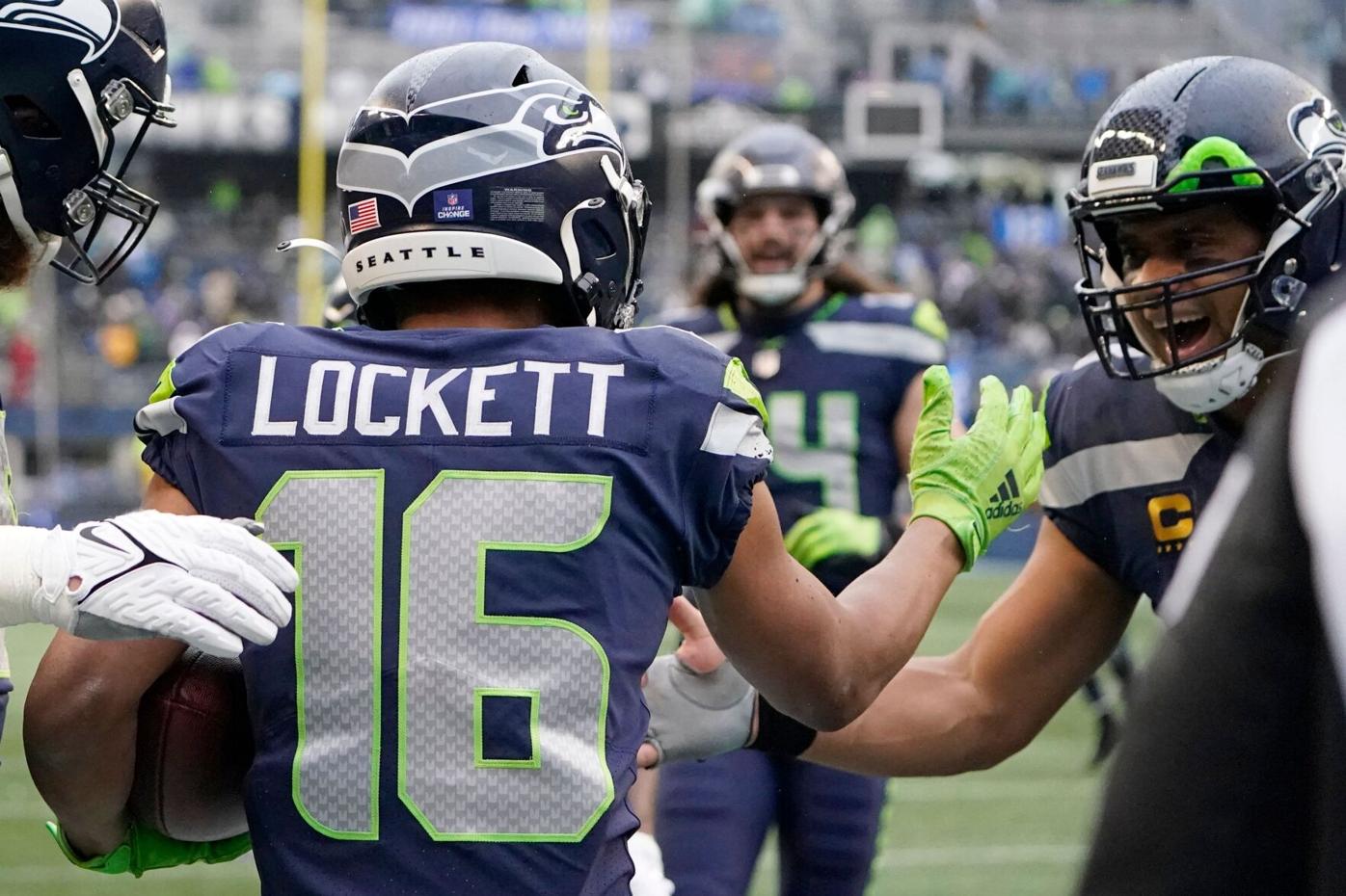 Wide receiver Tyler Lockett of the Seattle Seahawks smiles between