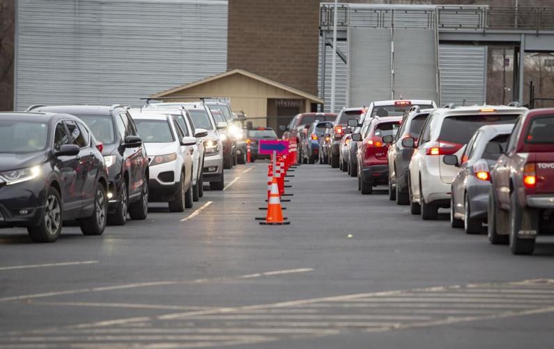 People line up in their cars in the Pendleton Convention Center parking lot