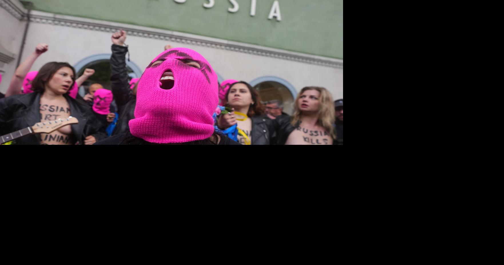 Protesters in pink balaclavas swarm Russia's pavilion at Venice Biennale and release colored smoke
