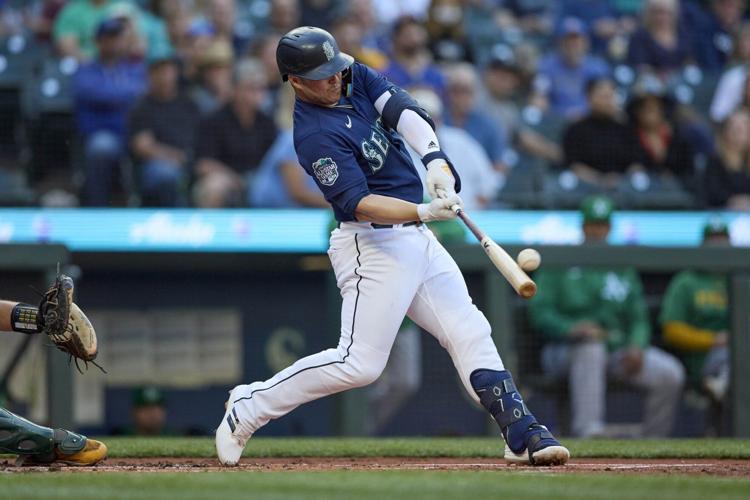 Seattle Mariners' Ty France removes his batting gear after