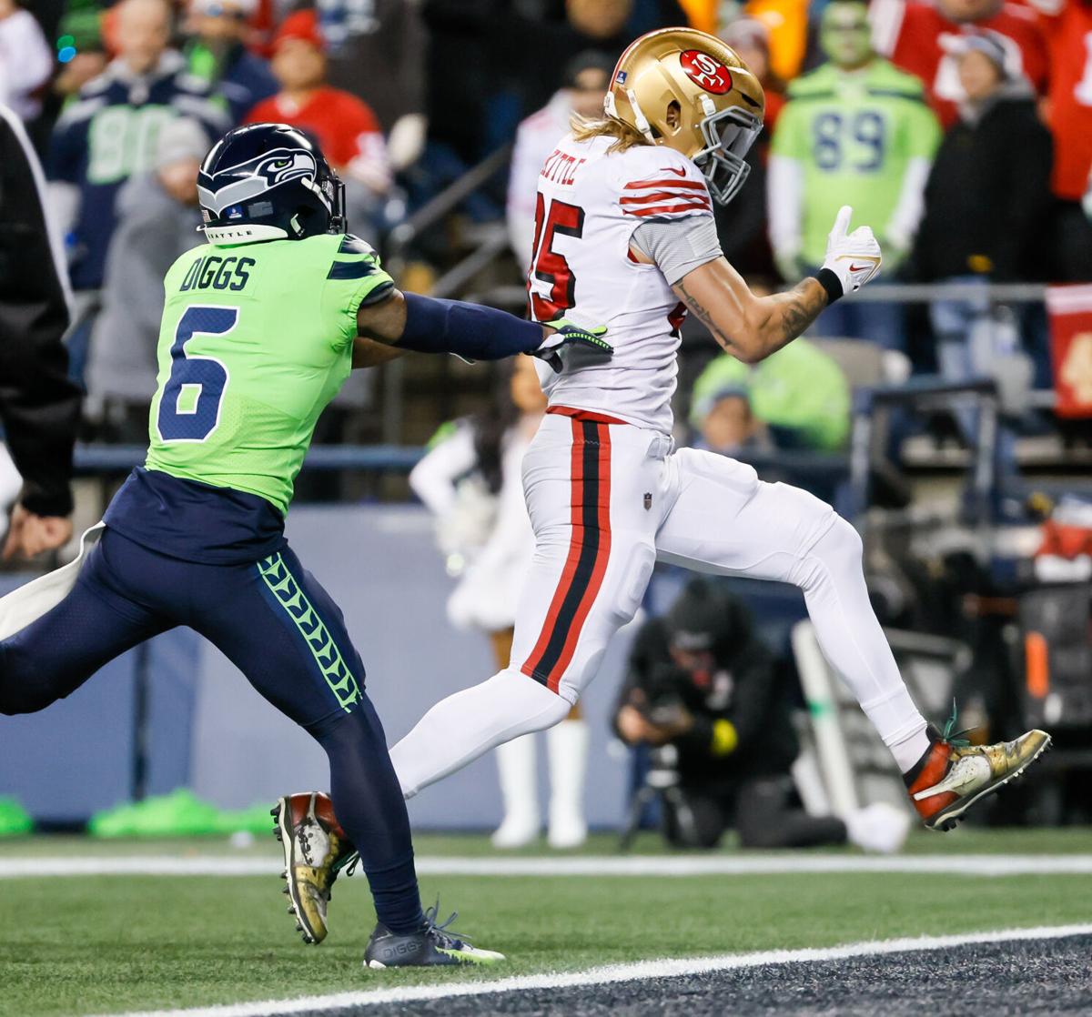 San Francisco 49ers quarterback Jimmy Garoppolo, left, avoids being sacked  by Seattle Seahawks …