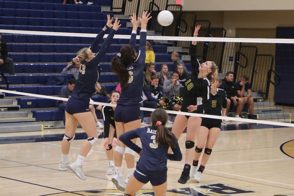 Raiders attackers Tessa Gallo, number 13, and Hannah Castillon, number 16, converge at the net to try to stop Sonora sophomore Hope Houck, number 18, Thursday night in a second-round match of the 2019 CIF Sac-Joaquin Section Volleyball Division III playoffs in Modesto.