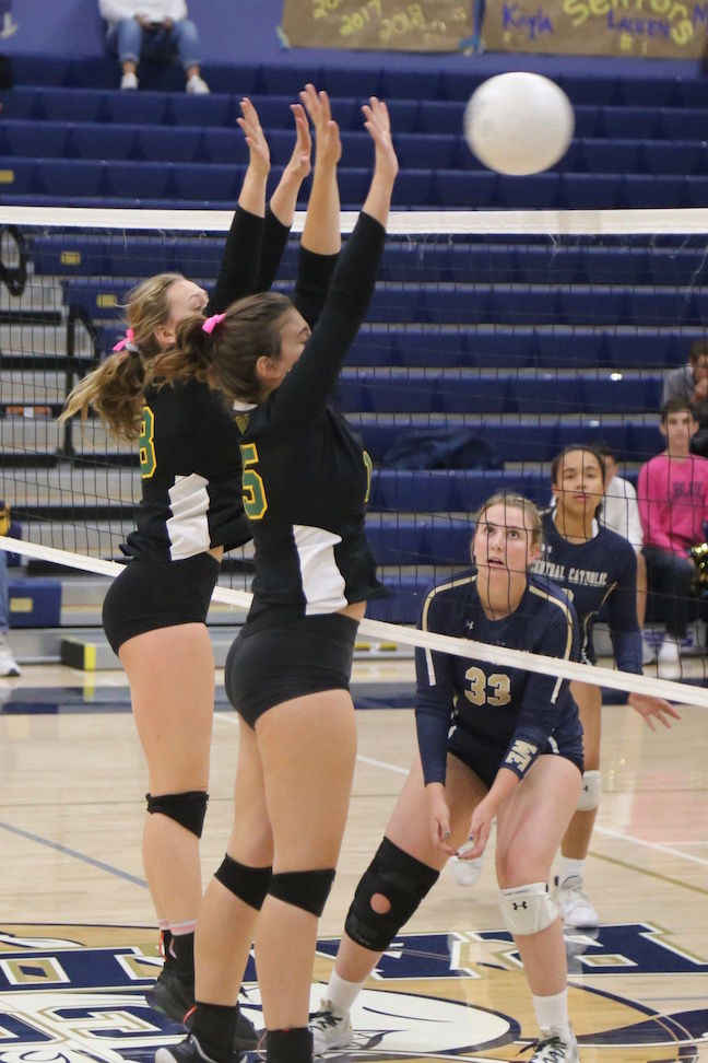 Sonora sophomore Hope Houck, number 18, and senior co-captain Ainslee Shuemake, number 15, defend against Central Catholic on Thursday night in a second-round match of the 2019 CIF Sac-Joaquin Section Volleyball Division III playoffs in Modesto.
