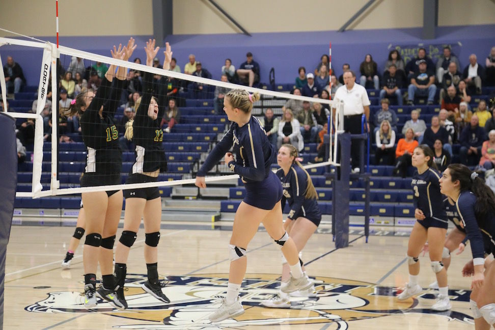 Sonora front row blockers Ainslee Shuemake, number 15, and Alexis Herfurth, number 17, rise to defend against Central Catholic as a Raider hitter follows through Thursday night, in a second-round match of the 2019 CIF Sac-Joaquin Section Volleyball Division III playoffs in Modesto.