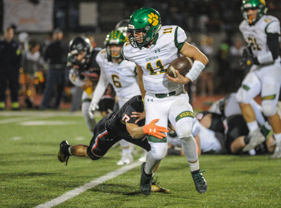 Sonora High's (11) Nick Crockett runs the ball for a first down during the high school game between the Sonora High School Wildcats and Summerville High School Bears at Summervilles Thorsted Field on November 1, 2019 in Tuolumne, CA.