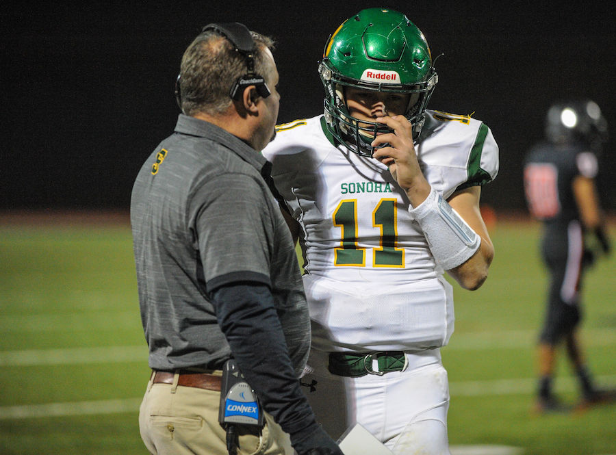 Sonora High's (11) Nick Crockett gets a play call in from the offensive coordinate during the high school game between the Sonora High School Wildcats and Summerville High School Bears at Summervilles Thorsted Field on November 1, 2019 in Tuolumne, CA.