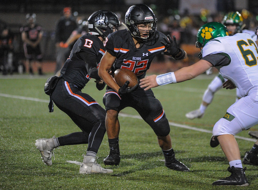 Summerville High's (22) Tommy Warfiled tries to stiff arm a Sonora player during the high school game between the Sonora High School Wildcats and Summerville High School Bears at Summervilles Thorsted Field on November 1, 2019 in Tuolumne, CA.