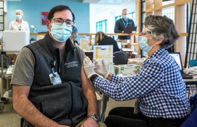 Dr. Michael Calderwood gets his COVID-19 vaccine