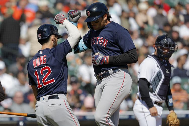 Adam Duvall of the Boston Red Sox is congratulated in the dugout