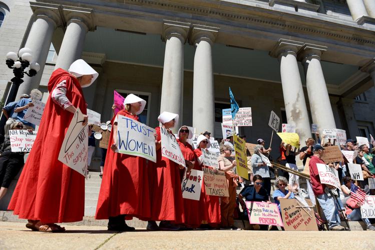"Handmaids" protest state budget at State House