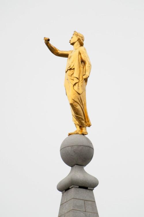 The Angel Moroni statue's outstretched hand appears empty after the trumpet toppled during a 5.7 magnitutude earthquake in Salt Lake City