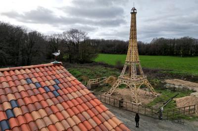 A French carpenter builds a replica of the Eiffel Tower from recycled wood in western France