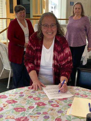 Jeanne Michon signing the lease