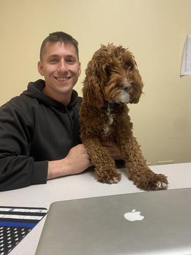 School Resource Office Ryan Perry and therapy dog Grace