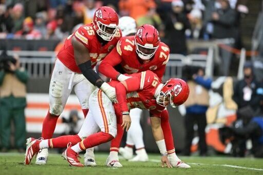 Kansas City Chiefs quarterback Patrick Mahomes is helped up his team-mates in Sunday's win over Cleveland. Mahomes suffered a right ankle injury during the game