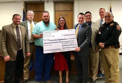 Victoria Apartment Association donates check to Victoria County Commissioners