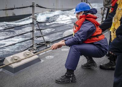 Talk of the Town: Victoria Sailor heaves in mooring line aboard U.S. Navy warship