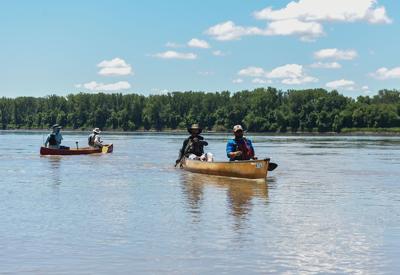 Canoes pass through the Missouri River during the Missouri American Water MR340 race on Wednesday