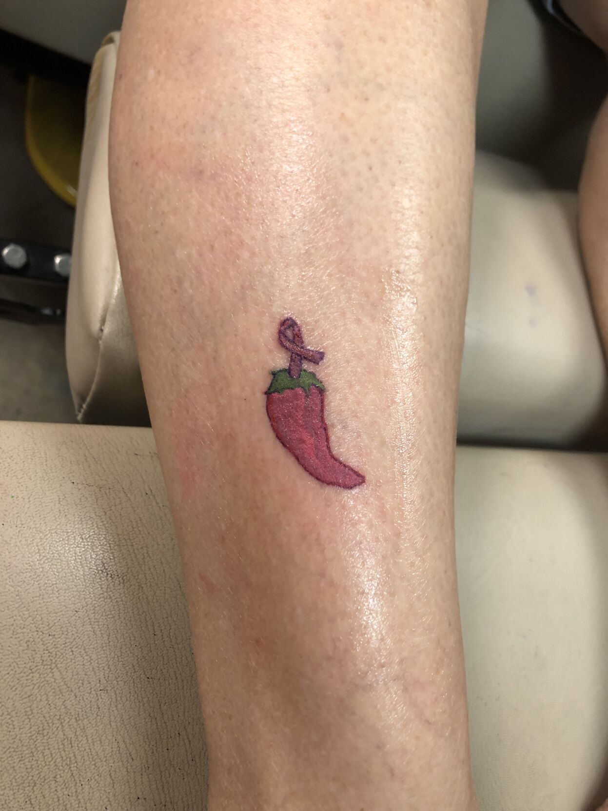 Realistic chilli pepper tattoo