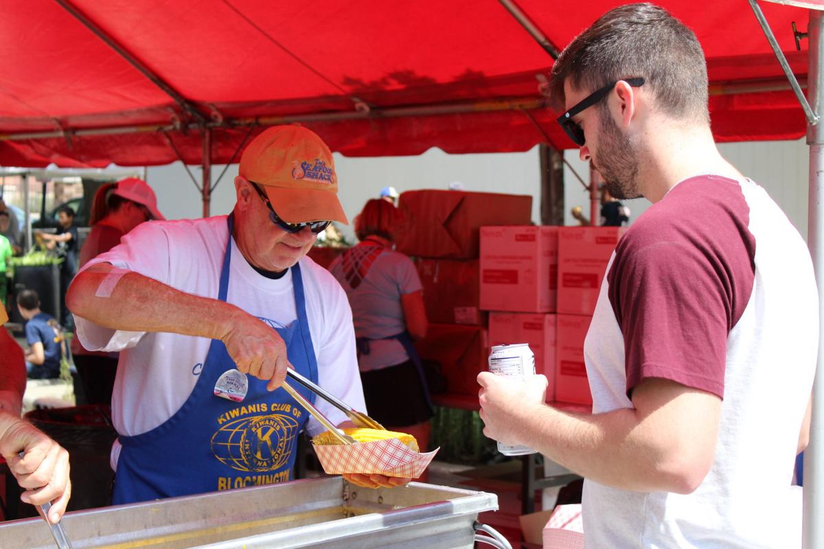 sweet corn fest handing out corn