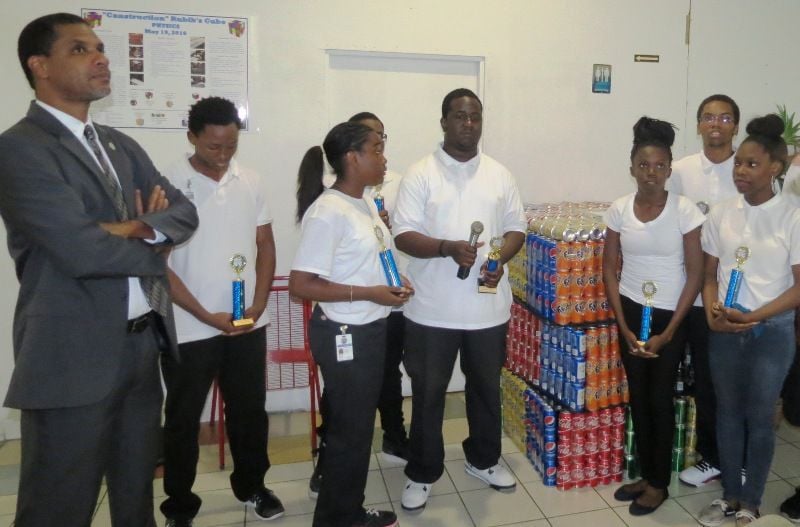 St. Croix Educational Complex physics students were awarded Excellence in Mathematics and Physics for their “CANSTRUCTION RUBIC’S CUBE” at St. Croix’s STEM Fair May 19-20. The physics students utilized 60 cases of assorted soda cans to form a gigantic rubik cube. Students, not in order are, Jordan Thomas, Nikkoya Cromwell, Barthelemy Peter, Elecyce Flemming, Cariece Browne, Leah Achille, Roshaun Titus, Natasha Sinanan, Darryle Cyrille and Tione Grant. The physics teacher Joanne Lewis. Rubic Cube.jpg