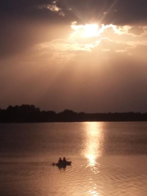 Kids kayaking at sunset on Lake Henry