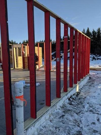 Red Boards line the garage of the Habitat Home