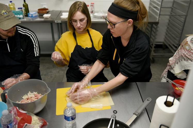 From left, Will and Rachel Mustain are helped by instructor Ashley Nichols on