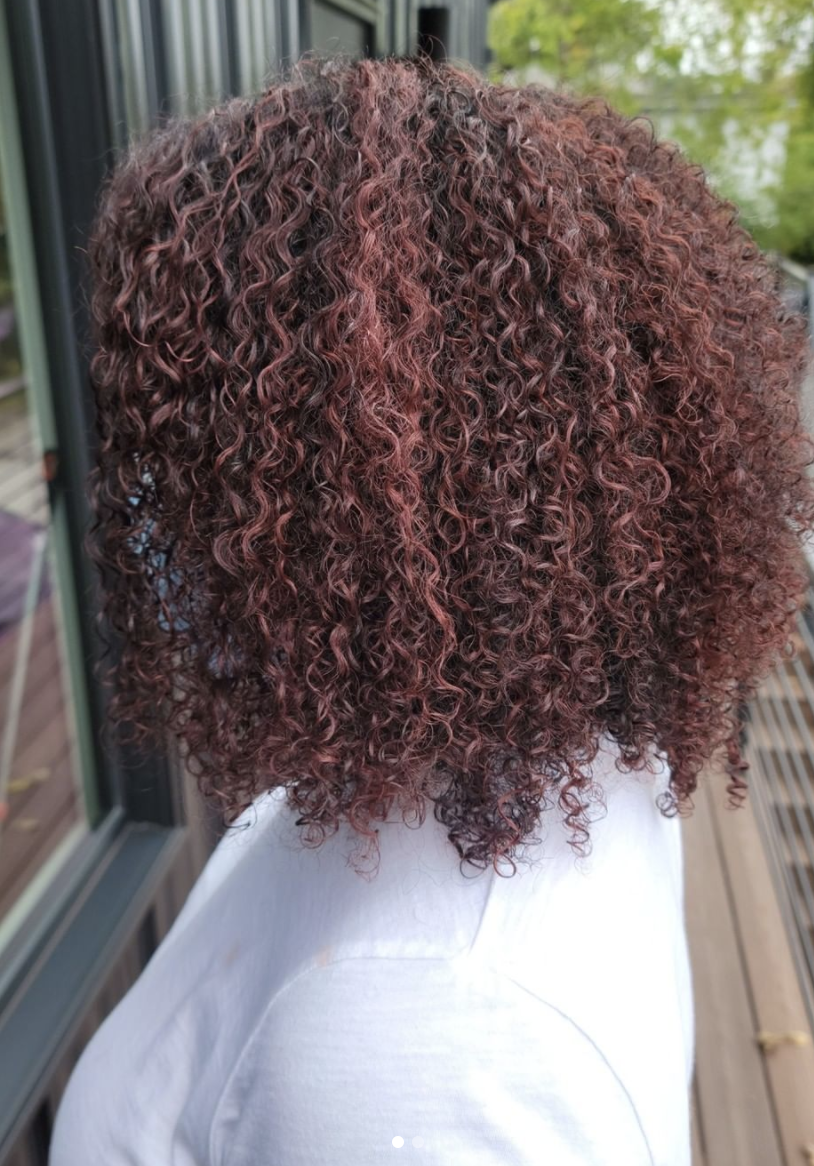 Curly dark red hair