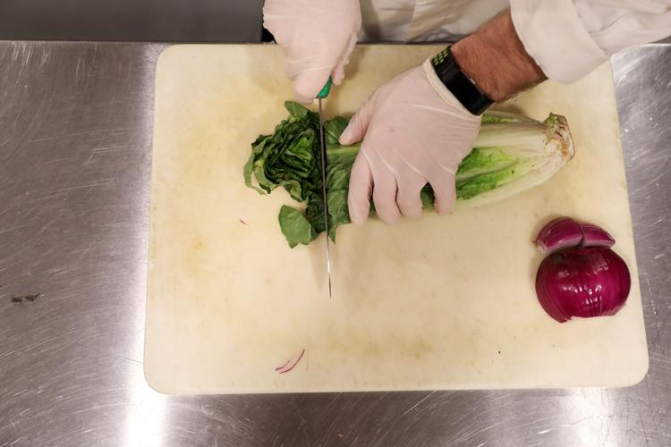 Chris Lammers prepares lettuce for lunch