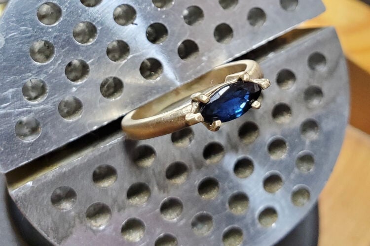 Elle Hinnah's favorite piece, an 18-karat gold engagement ring with a sapphire