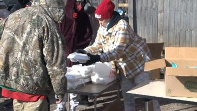 woman serving homeless food