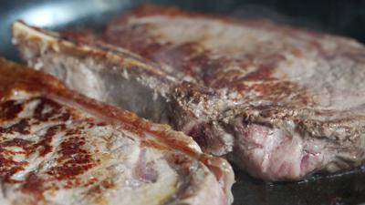 Steaks cooking in a pan